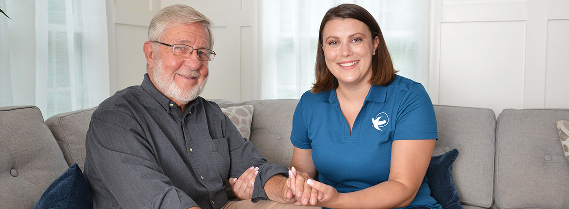 provider of home care in Edmonton sitting with elderly patient