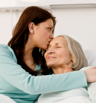 daughter kissing mother's forehead